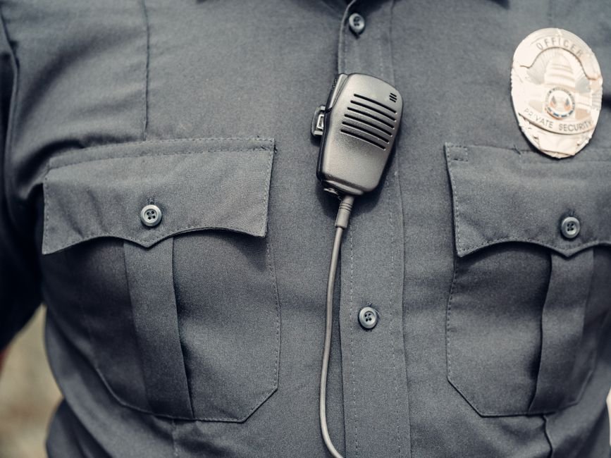 An ICE agent with body camera equipment during an enforcement operation