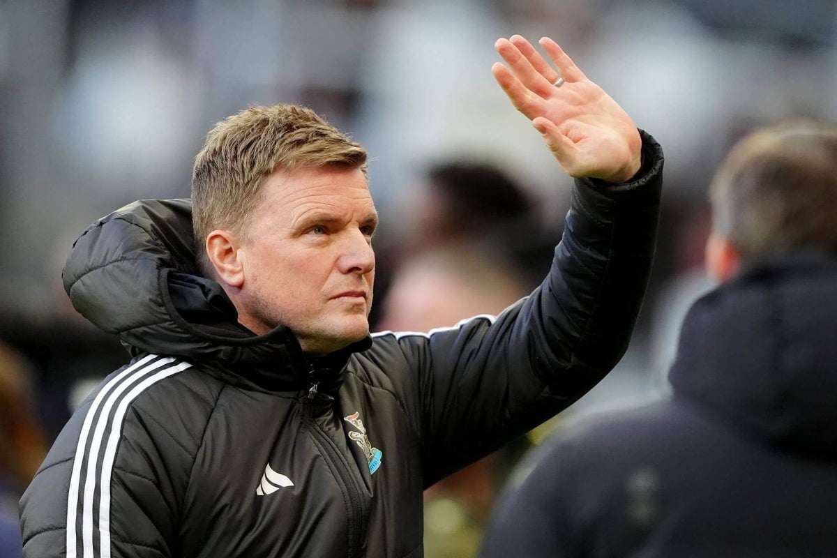 Eddie Howe on the touchline during a Newcastle United match, looking toward the pitch