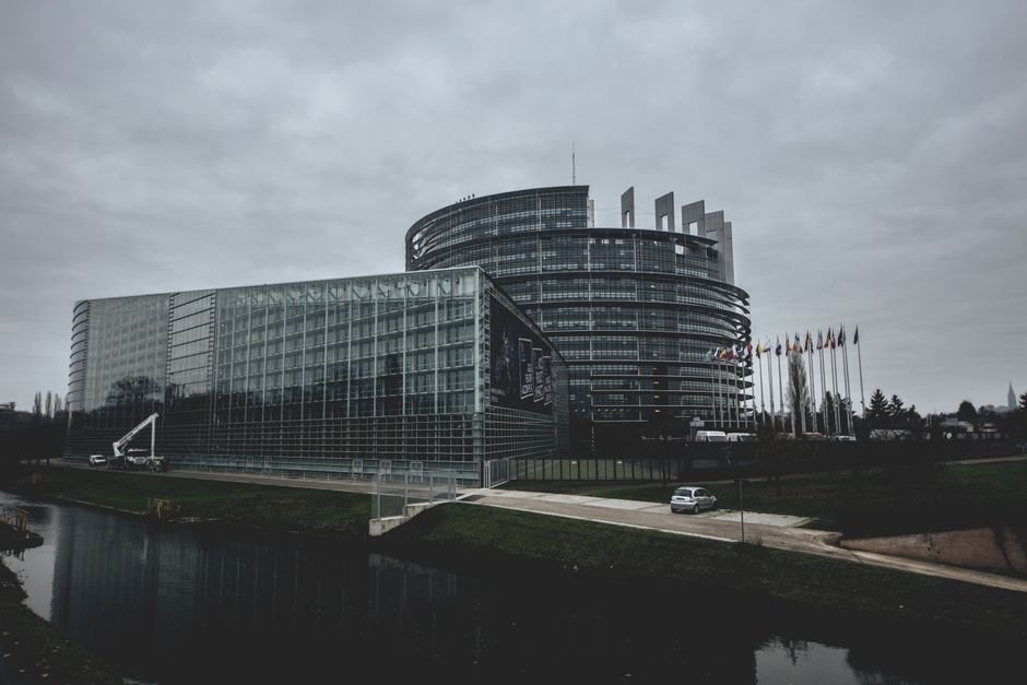 Modern architecture of the European Parliament in Strasbourg on a cloudy day.